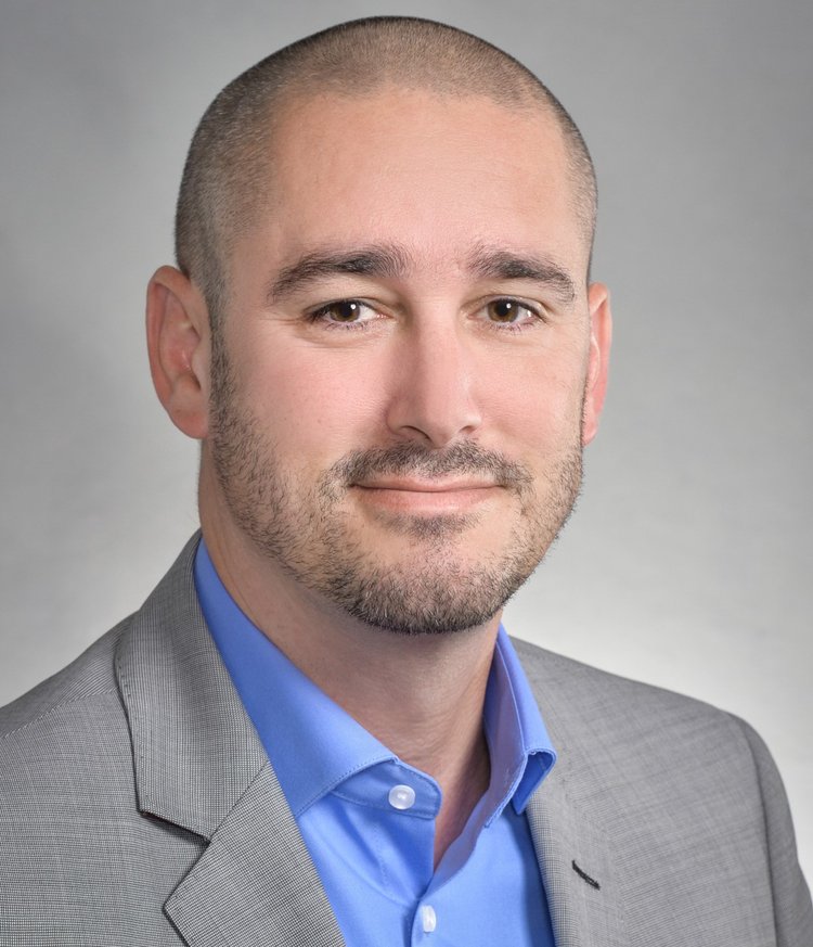 Headshot of Andy Kirby, smiling and looking directly at the camera.